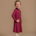 Girls' bamboo long-sleeve turtleneck dress in burgundy, offering modest style, soft comfort, and all-day wear.