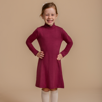 Girls' bamboo long-sleeve turtleneck dress in burgundy, offering modest style, soft comfort, and all-day wear.