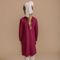 Girls' bamboo long-sleeve turtleneck dress in burgundy, offering modest style, soft comfort, and all-day wear.