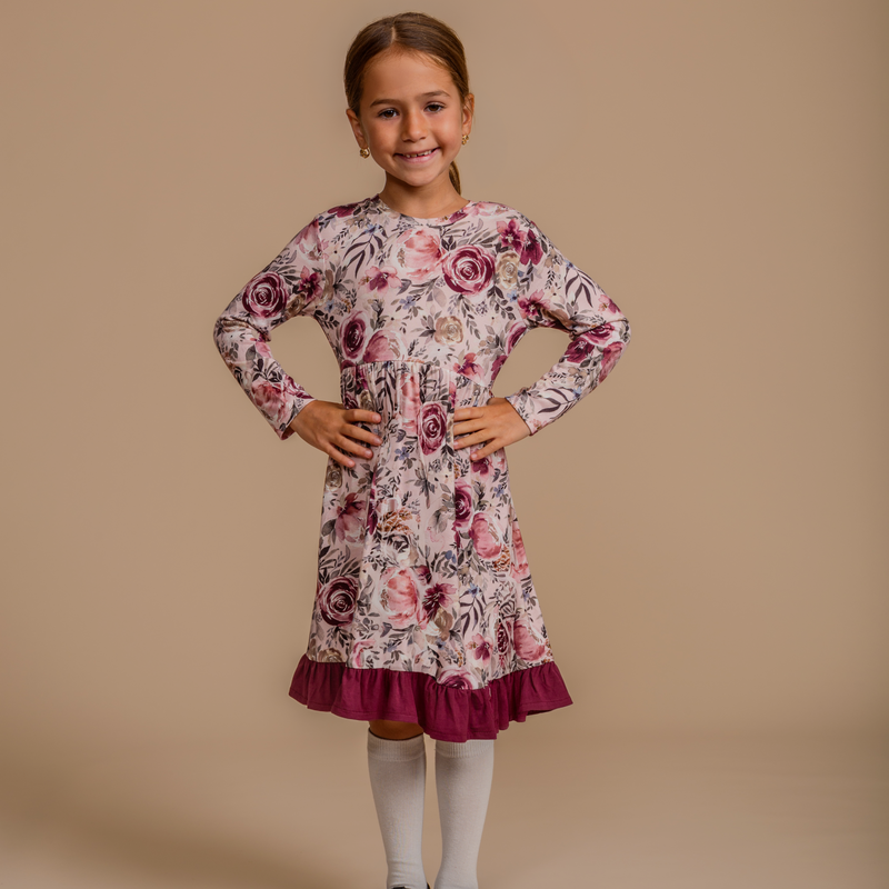 Girls' bamboo long-sleeve floral dress with a ruffle hem, offering modest style, soft comfort, and all-day wear.