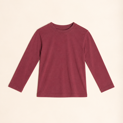A long-sleeve crewneck t-shirt in a dusty burgundy color, laid flat against a warm cream background.