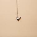 Silver letter V pendant necklace with a polished finish, offering a timeless, personalized design for everyday wear and thoughtful gifting.