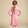 Girls' bamboo long-sleeve turtleneck top in pink with a pink bamboo pleated skirt, offering modest style, soft comfort, and all-day wear.