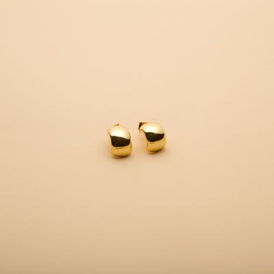 Polished gold dome hoop earrings with a timeless, elegant design, perfect for everyday wear and effortless style.