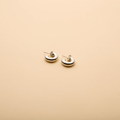 Polished silver dome stud earrings with a timeless, minimalist design, perfect for everyday wear and effortless style.