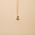 Gold letter E pendant necklace with a polished finish, offering a timeless, personalized design for everyday wear and thoughtful gifting.