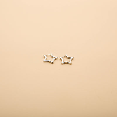 Silver open star hoop earrings with a minimalist, timeless design, perfect for everyday wear and effortless style.