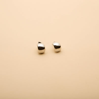 Polished silver dome hoop earrings with a timeless, elegant design, perfect for everyday wear and effortless style.