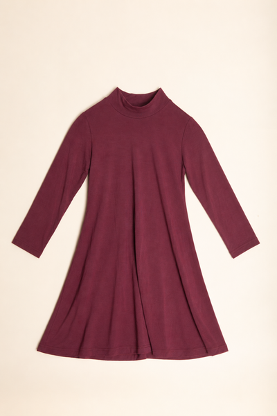 A long-sleeve mock neck dress in a deep burgundy or maroon color, laid flat against a light cream background.